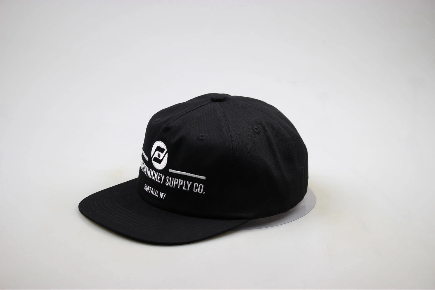 Black cap with white text and logo on a light gray background